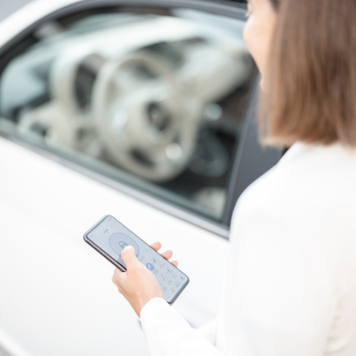 A women on her phone with car depicting the ota updates in cars